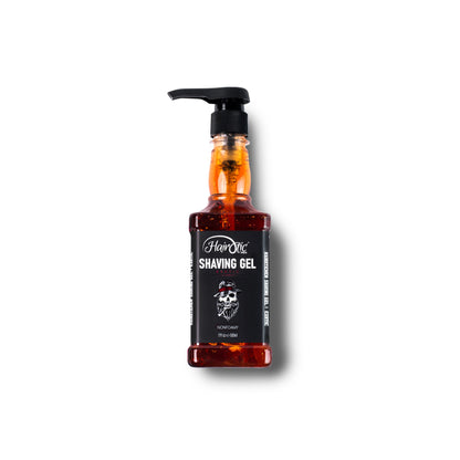 Orangefarbene Flasche Hairotic Professional Shaving Gel Exotic, 500 ml, mit Pumpspender und schwarzem Etikett mit Totenkopf-Logo, freigestellt auf weißem Hintergrund.
